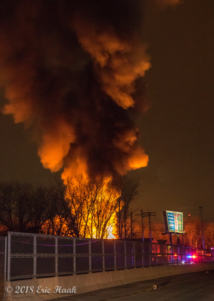 massive flames and smoke from industrial fire at night