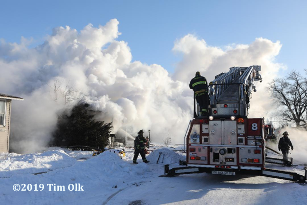 Firefighters battle house fire in frigid weather