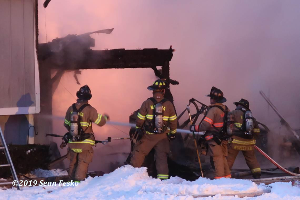 Firefighters at winter house fire scene