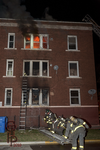 fire in a 3-story apartment building in Chicago at night