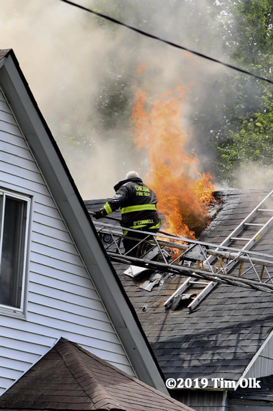flames through roof of house