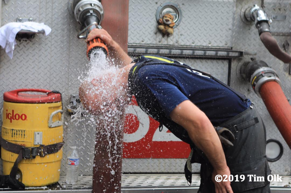 Firefighter cools down on a hot day