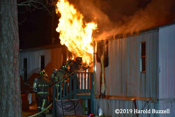 mobile home engulfed in fire at night