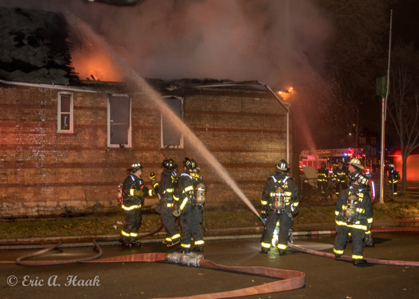 Firefighters with hose line at night