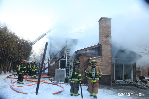 Firefighters battle a basement fire