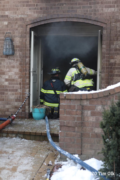 Firefighters battle a basement fire