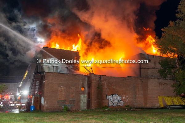 flames engulf vacant commercial building