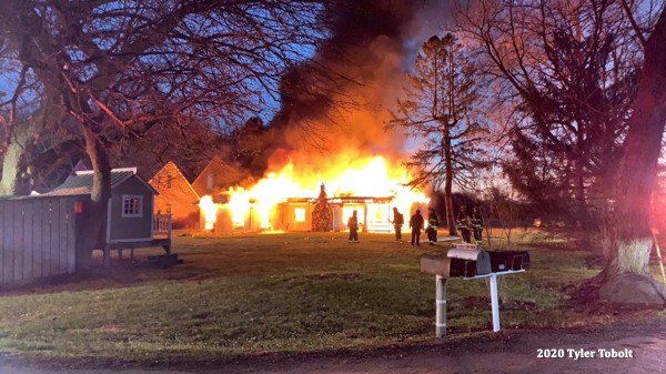 house engulfed by fire at night